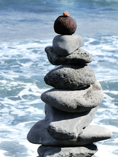 a stack of rocks sitting on top of a beach