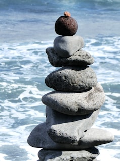 a stack of rocks sitting on top of a beach
