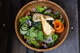 A colorful array of fresh salads in a rustic bowl.