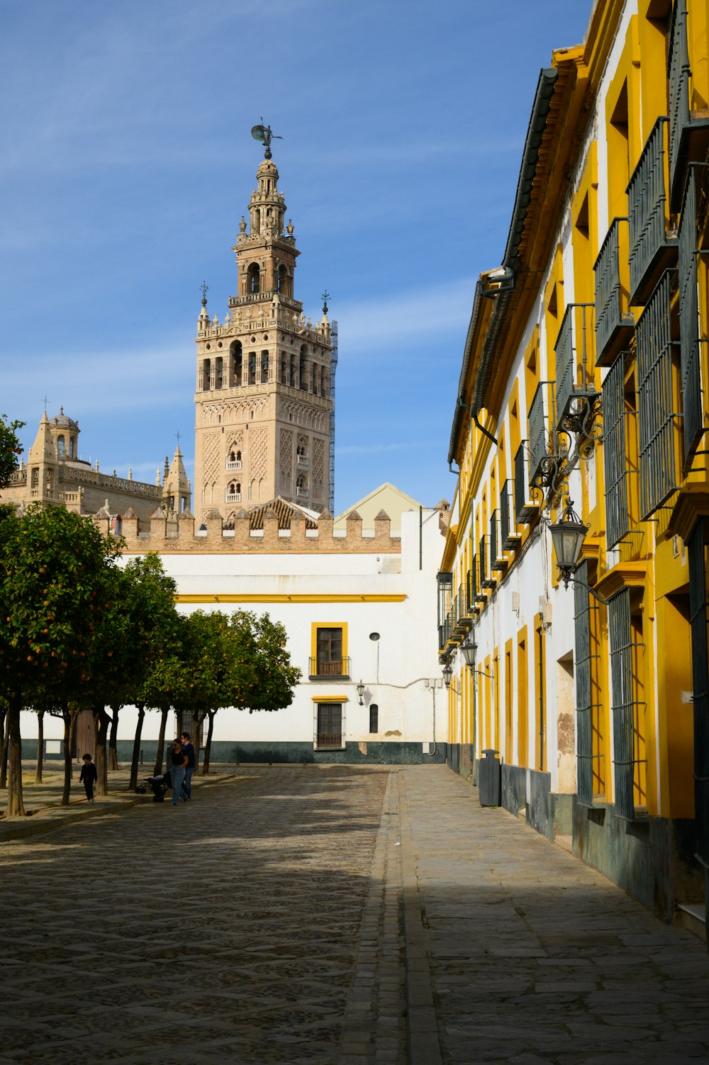 a yellow building with a clock tower in the background