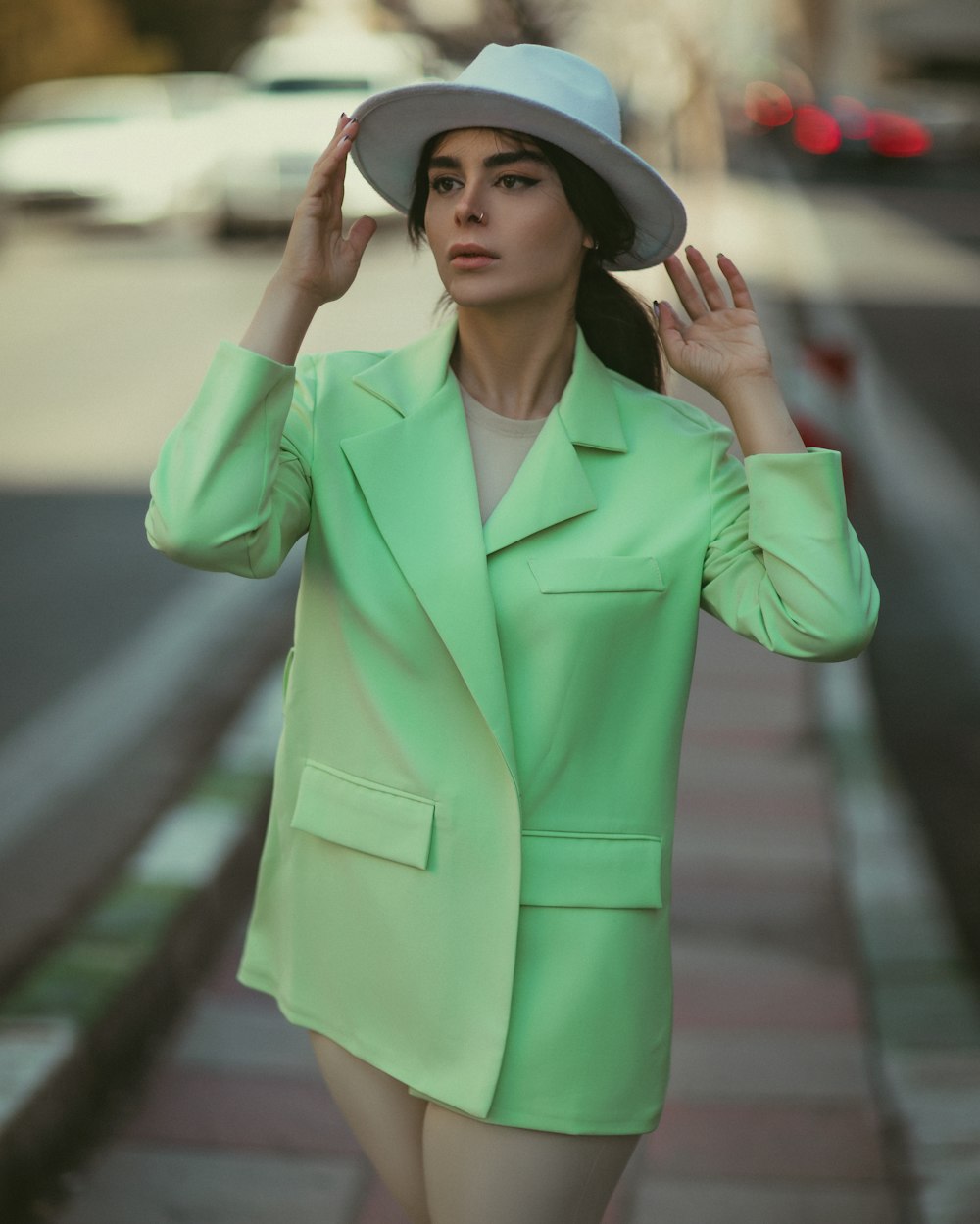 a woman wearing a green suit and hat