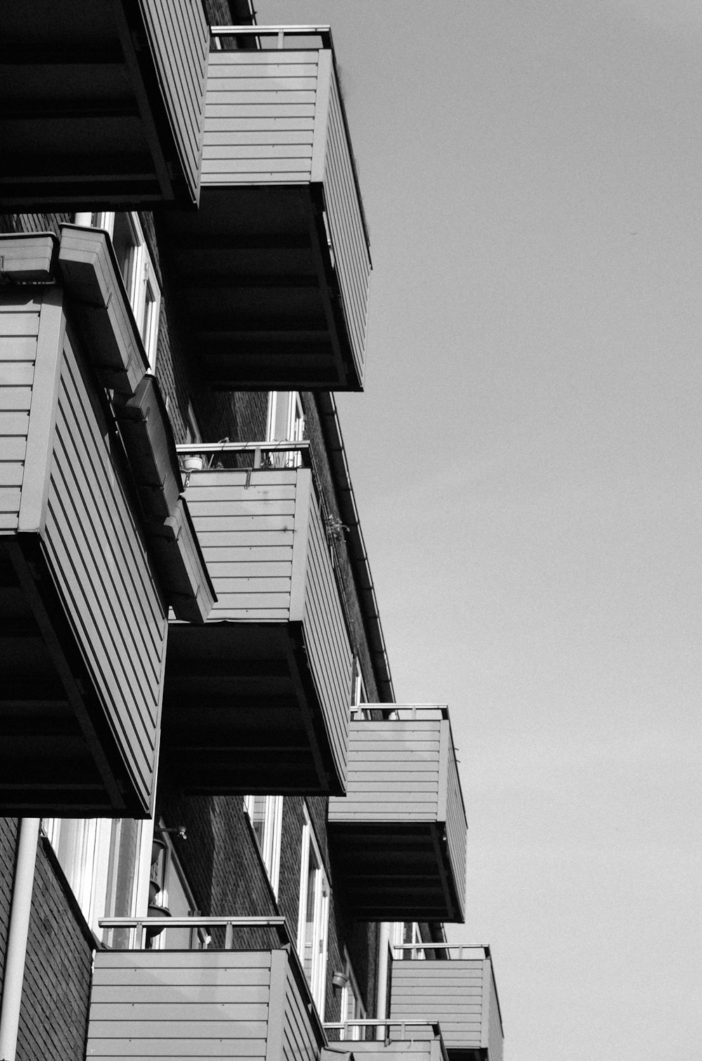 a black and white photo of a building with balconies