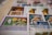 A collection of various postage stamps arranged in a slightly overlapping manner. The stamps feature diverse designs, including portraits of historical figures, botanical illustrations, and colorful artistic depictions. The focal stamp shows a portrait of a man with white hair beside a botanical drawing of yellow flowers on a green background.