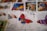 A collection of colorful postage stamps featuring butterfly illustrations. The focus is on a stamp with a vibrant butterfly in red, blue, and brown hues. Other stamps with different butterfly designs and colors are visible in the background, creating an artistic and eclectic display.