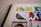 A collection of colorful postage stamps is displayed, featuring various designs including a bird, abstract shapes, and a portrait. The stamps are affixed to an album page, with some text visible in Cyrillic script.