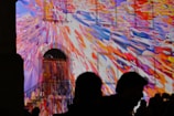 Abstract colorful light projections on urban building walls.