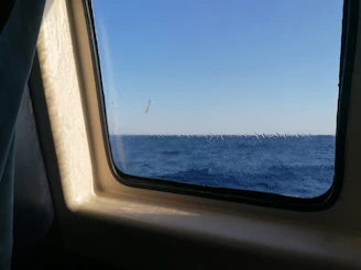 A team meeting by a window overlooking the sea.