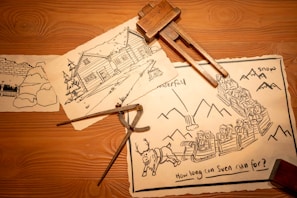 Multiple laser-cut wooden maps of lakes and ski hills arranged on a rustic wooden table.