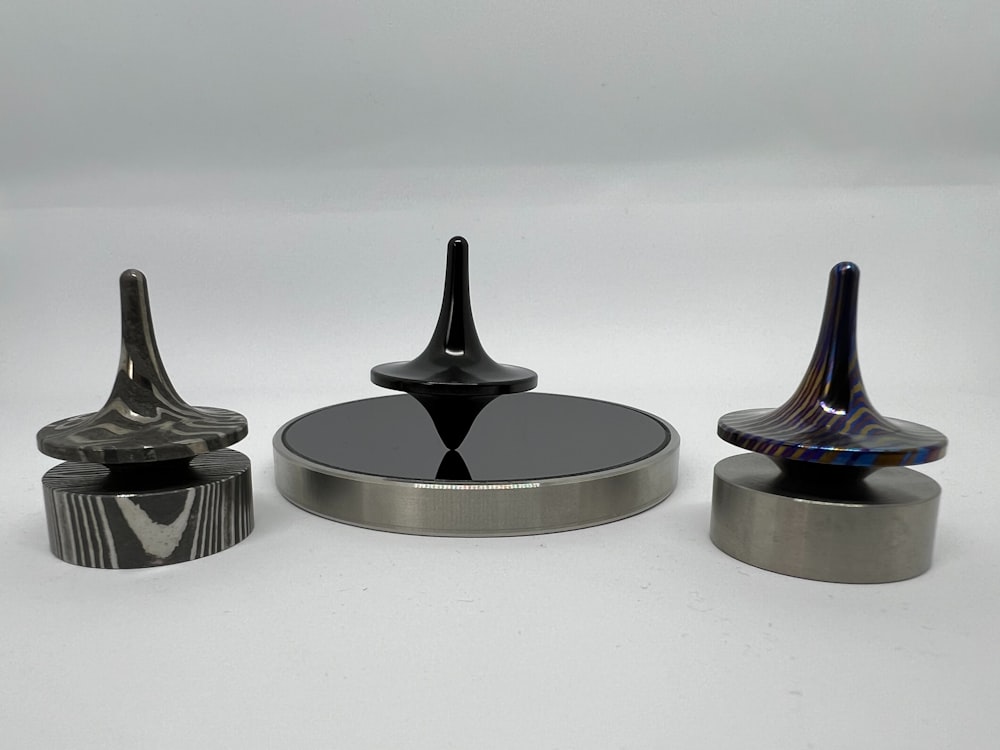 a group of three black and silver objects