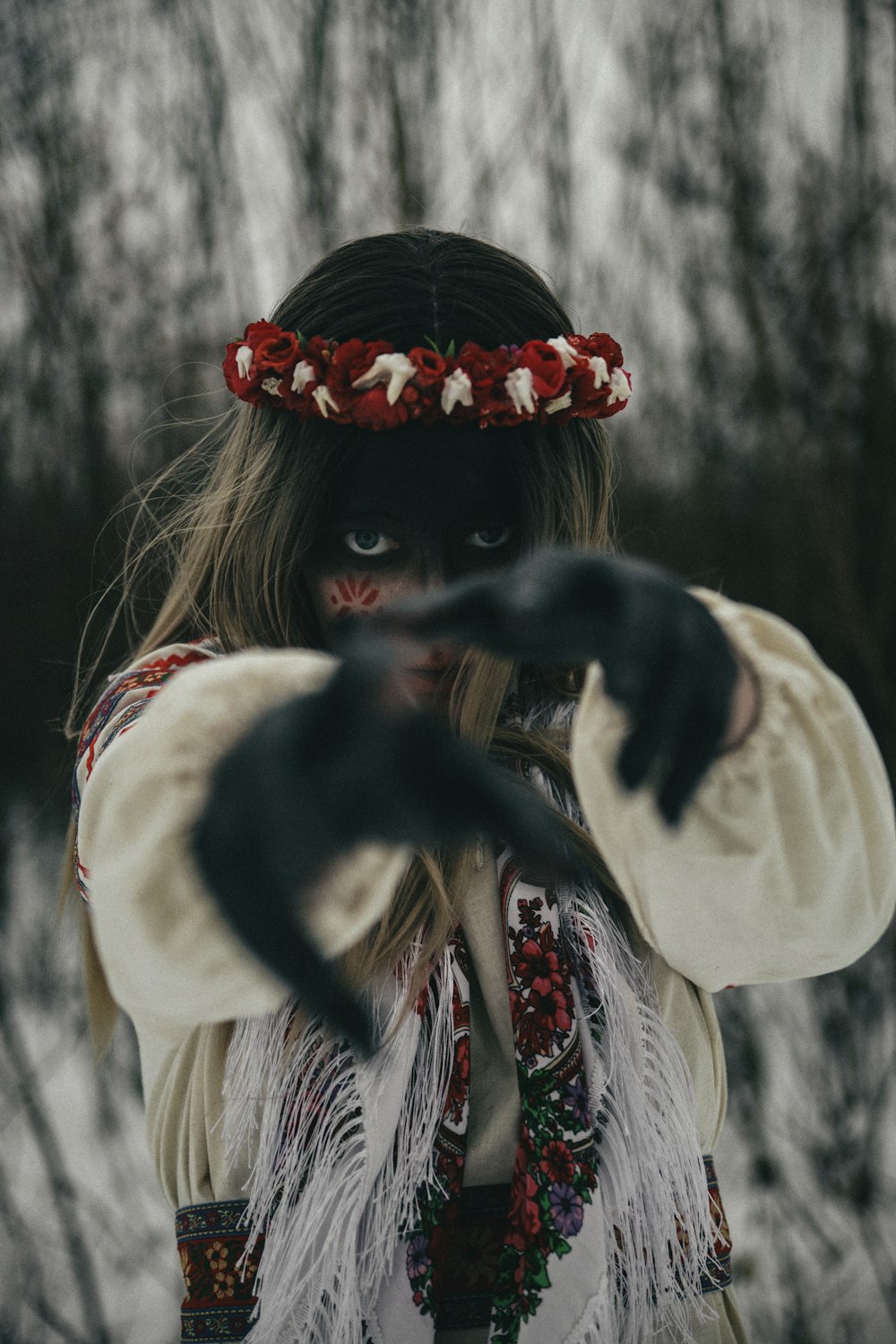 a woman wearing a headdress and holding out her hands