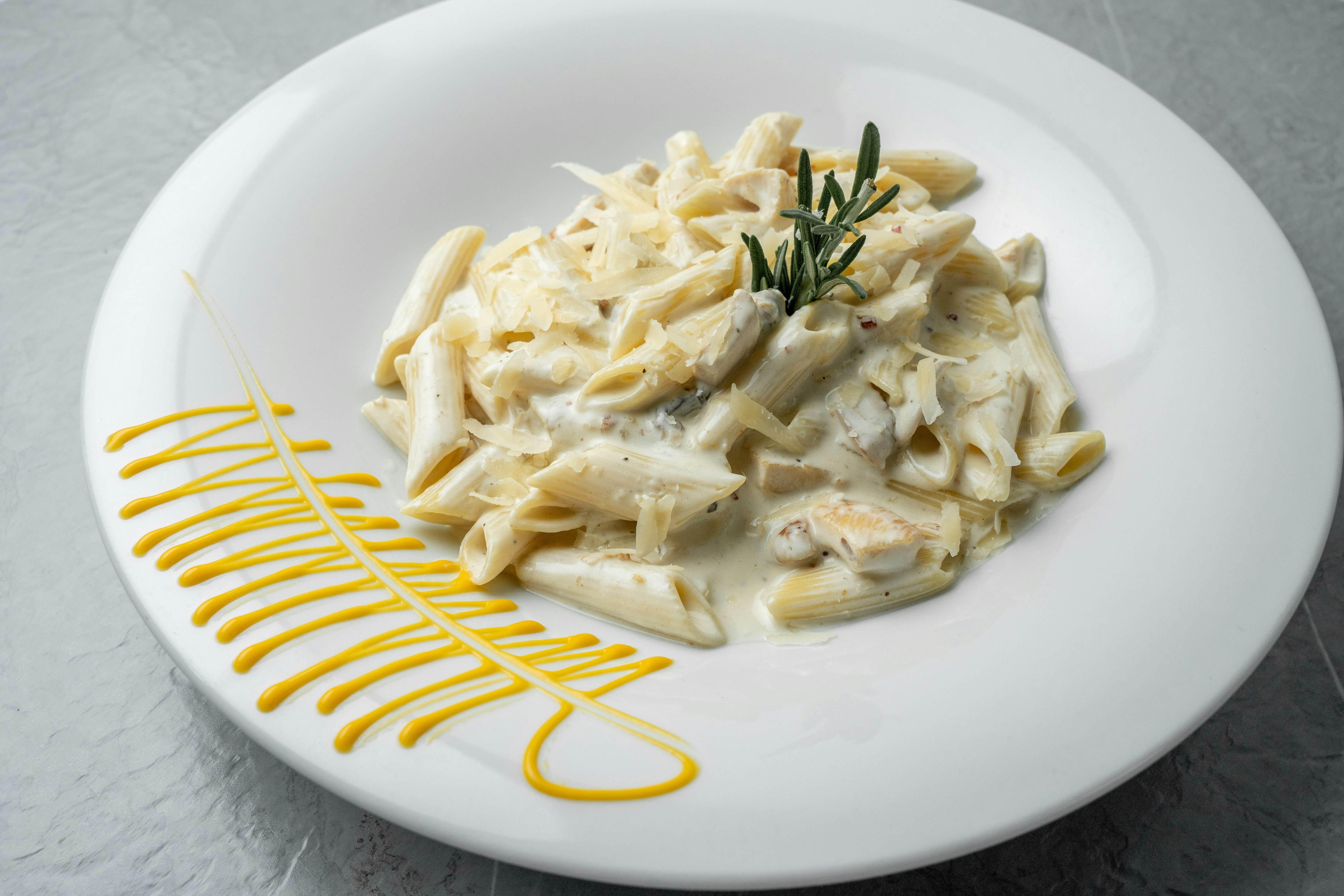a white plate topped with pasta and sauce