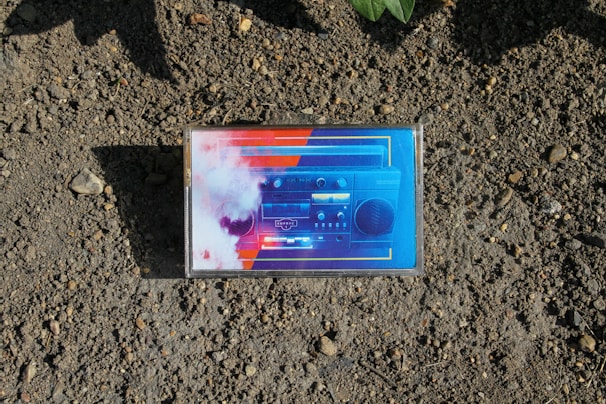 An old-school cassette tape with vibrant graffiti art in the background.