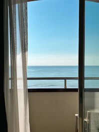 a balcony with a view of the ocean