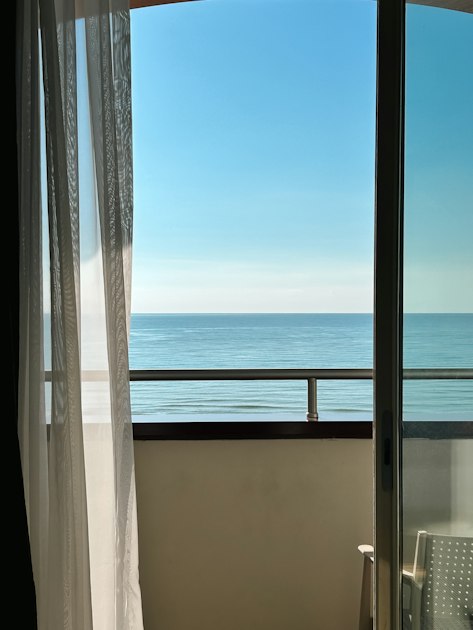 An apartment balcony overlooking the ocean, typical of Gold Coast strata units listed on Airbnb