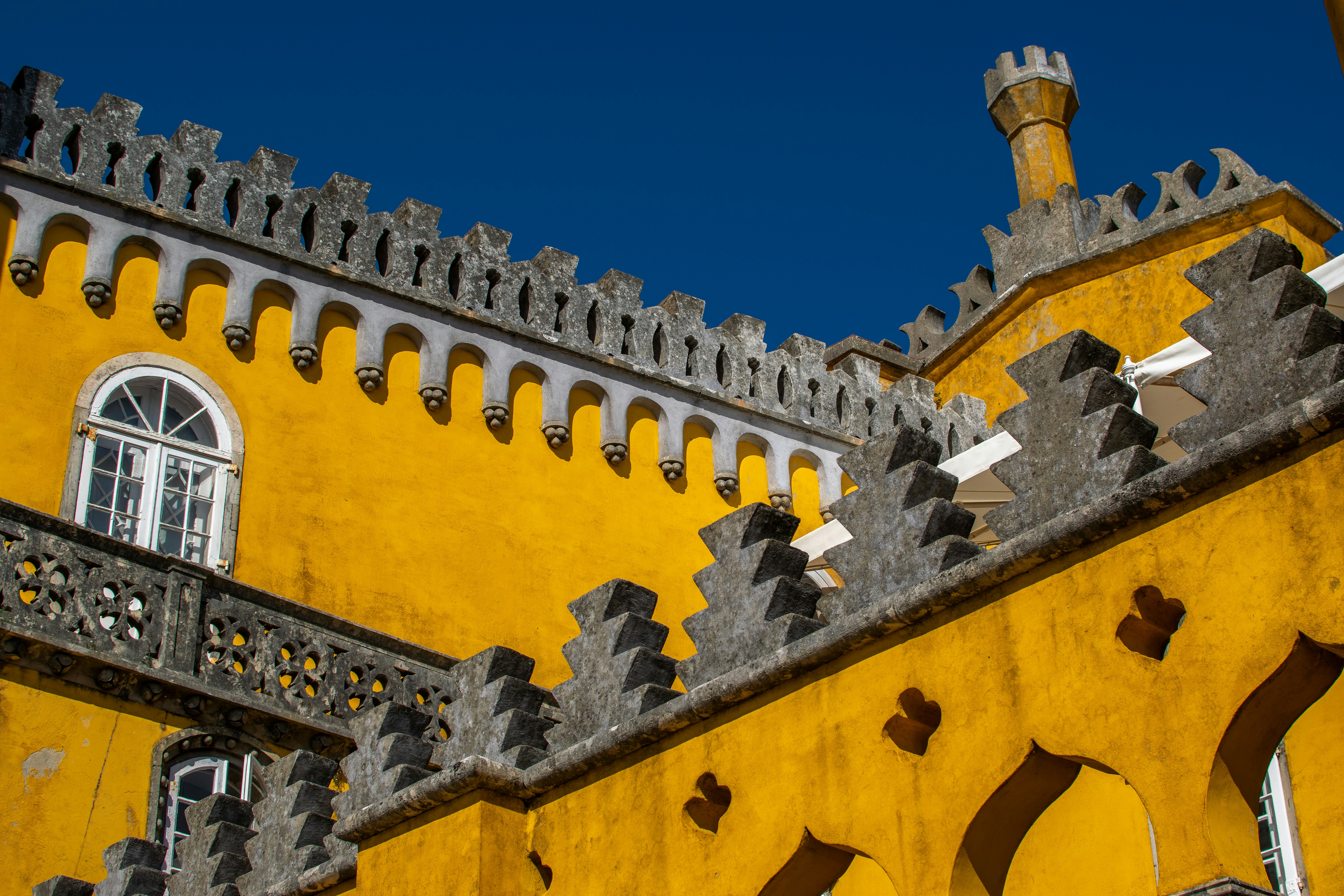 a large yellow building with a clock on the side of it, Pena Palace in Sintra, Portugal