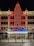 The image features the front facade of a performing arts center named Providence. The building is ornately decorated, with a large vertical neon sign displaying 'PROVIDENCE' twice. The entrance is brightly lit with a marquee sign advertising a '2024 IPMA launch party' scheduled for December 9, 2023. The architecture is detailed and well-lit, especially in the nighttime setting. There are two people standing near the entrance.