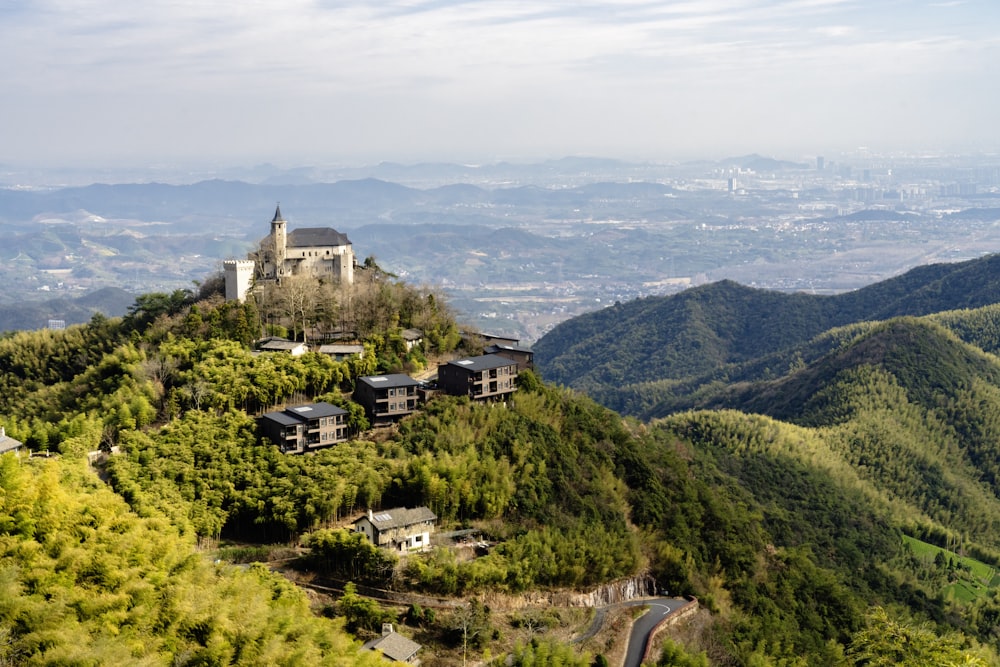 a castle on top of a hill surrounded by trees