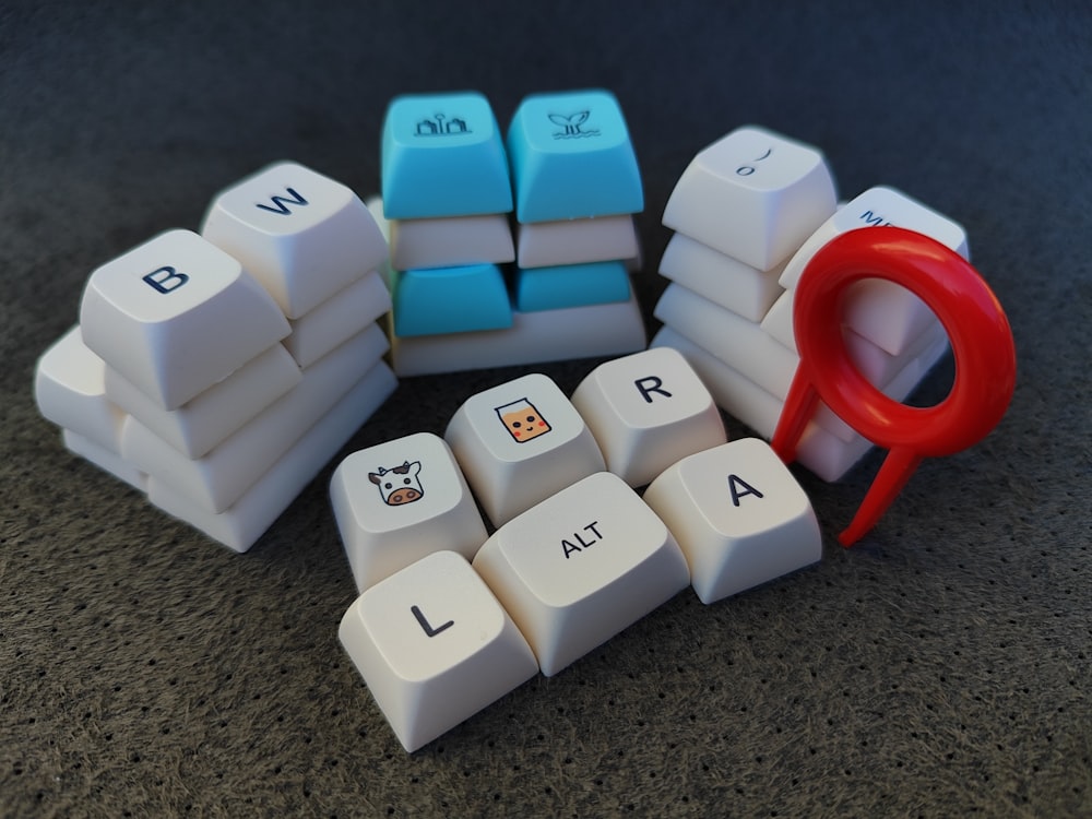 a computer keyboard with a pair of scissors next to it