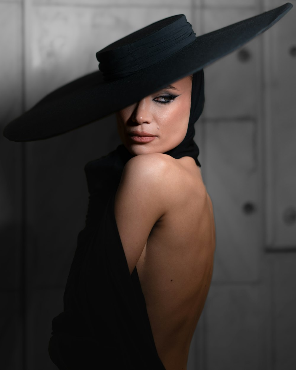a woman with a black hat on her head