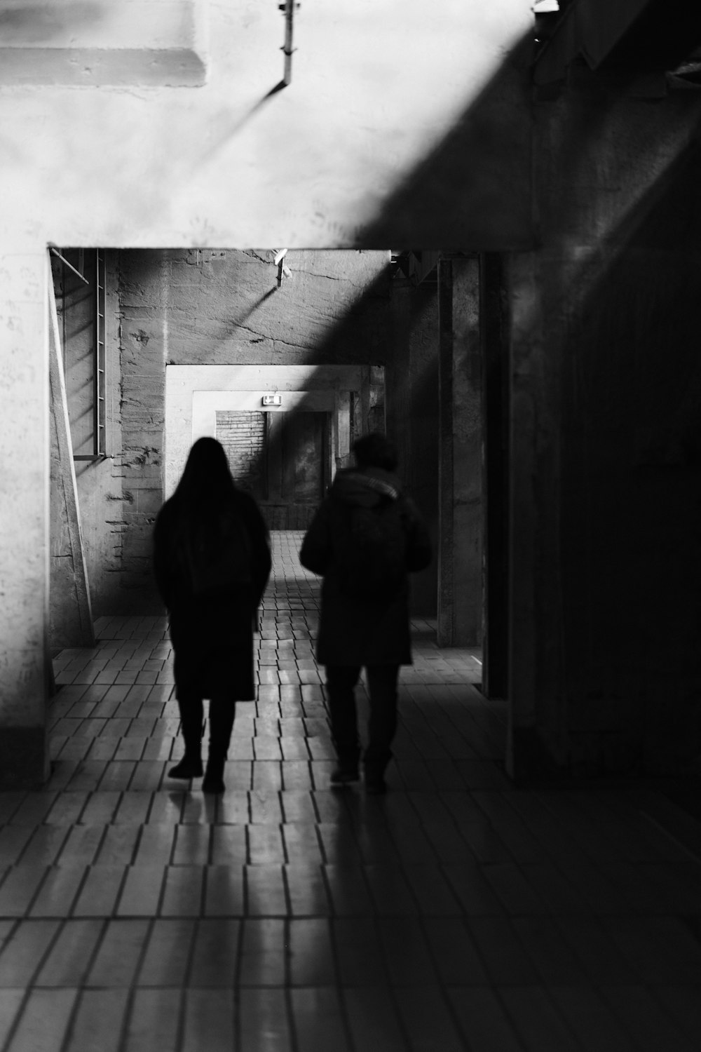 un couple de personnes marchant dans un couloir