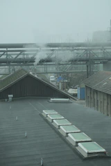 Wet scrubber system operating with visible mist in a factory setting.