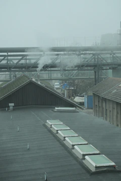 Wet scrubber system operating with visible mist in a factory setting.