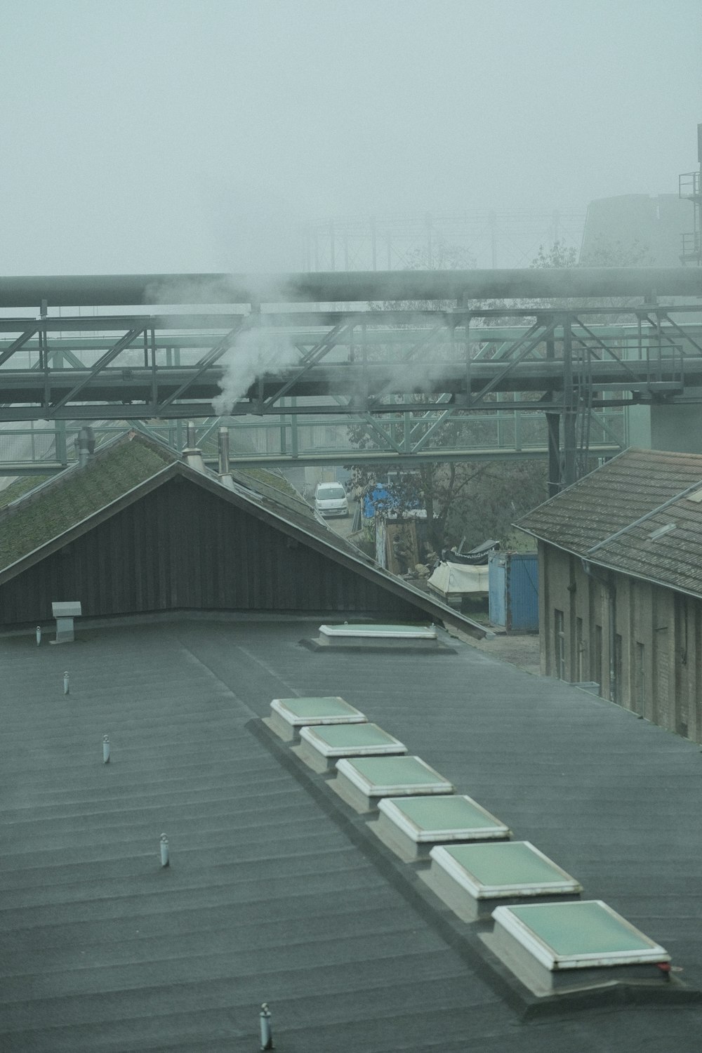 smoke billows from the roof of an industrial building