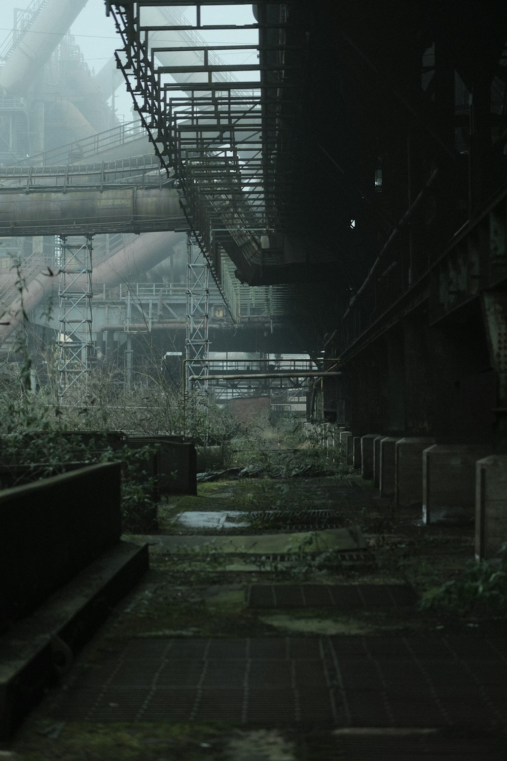 an abandoned factory building with stairs leading up to it