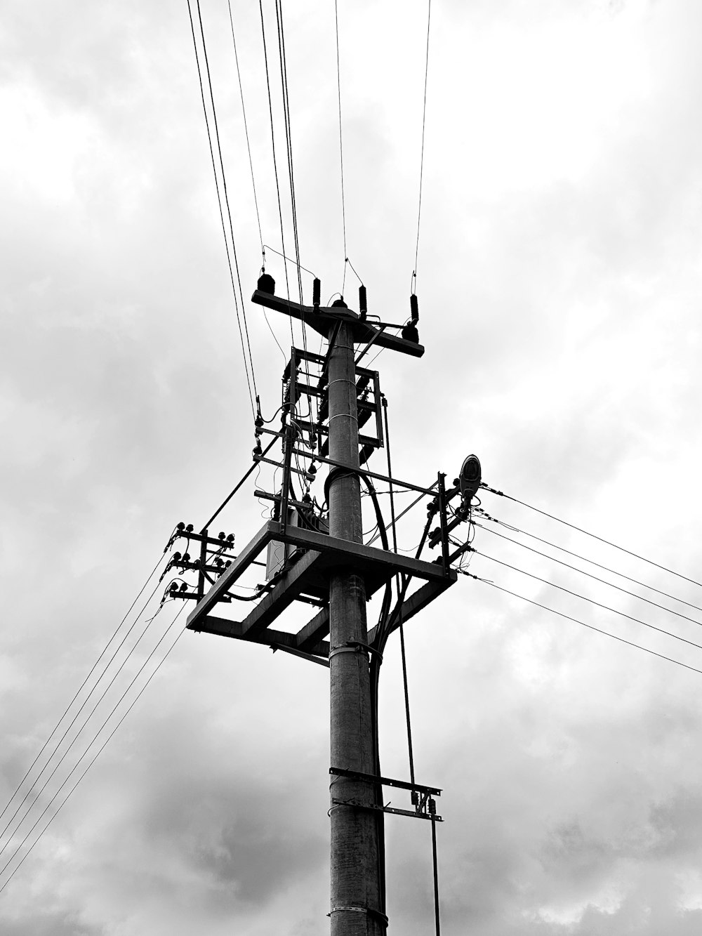 a black and white photo of a power pole