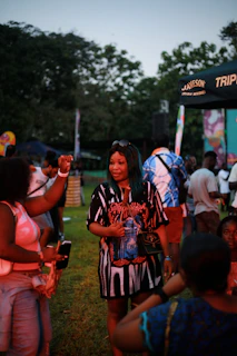 A group of happy festival visitors sitting nearby, sharing water and chatting during an IV break.