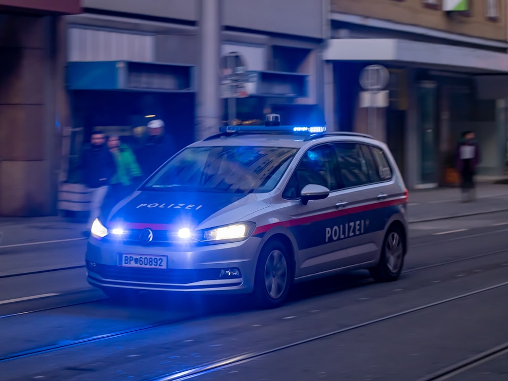 a police car driving down a city street