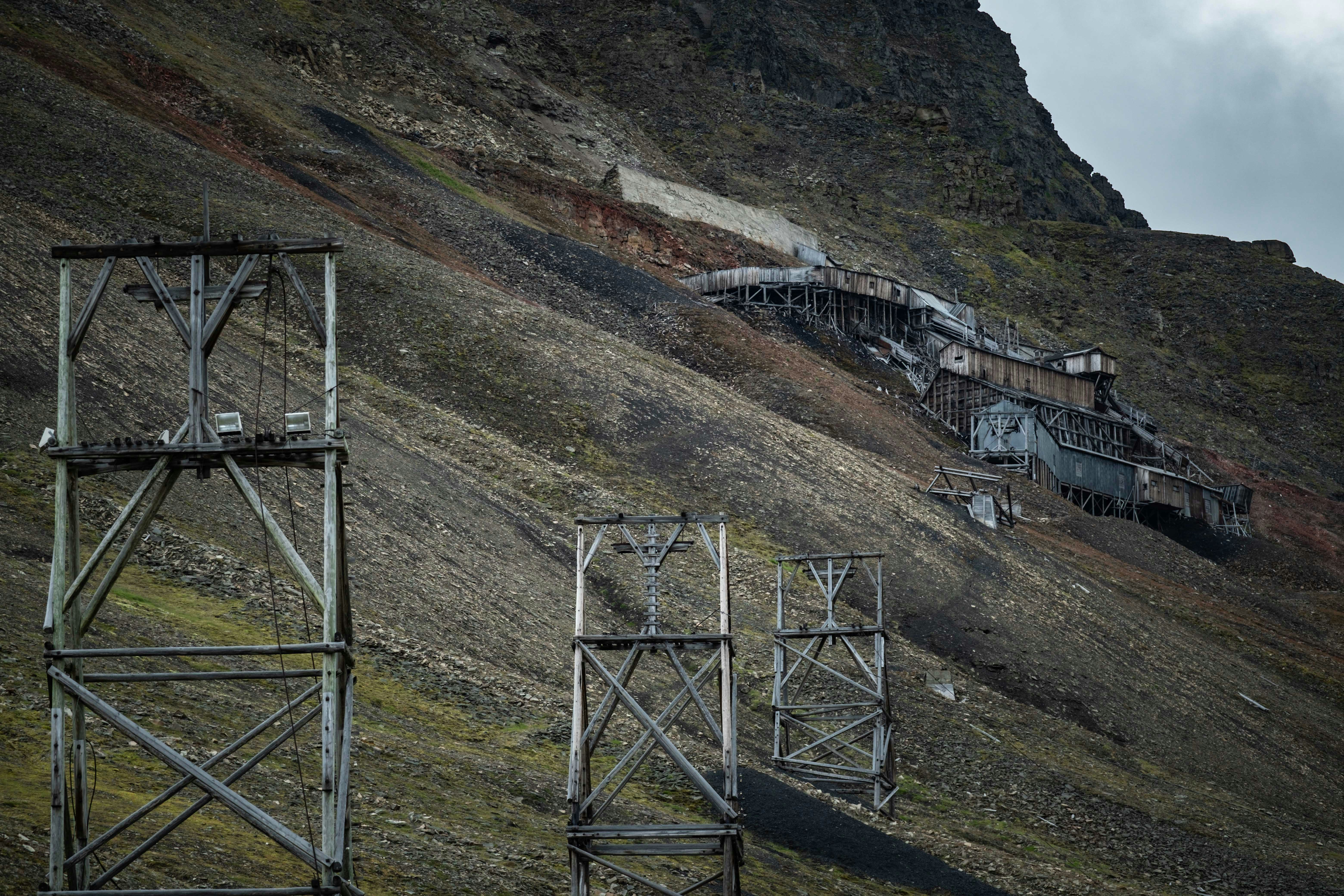 A couple of metal structures sitting on the side of a mountain photo ...
