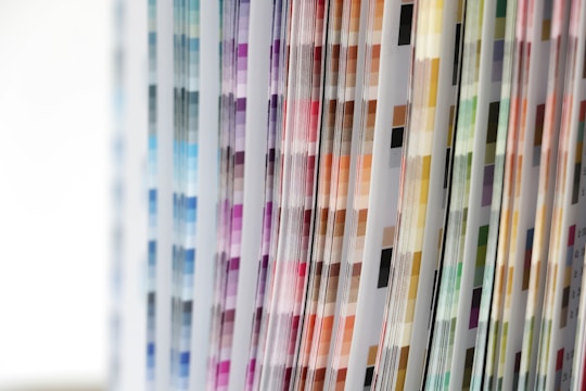 Various pages with vertical columns of color swatches arranged in a pattern, displaying a spectrum ranging from blues and purples to browns and greens.