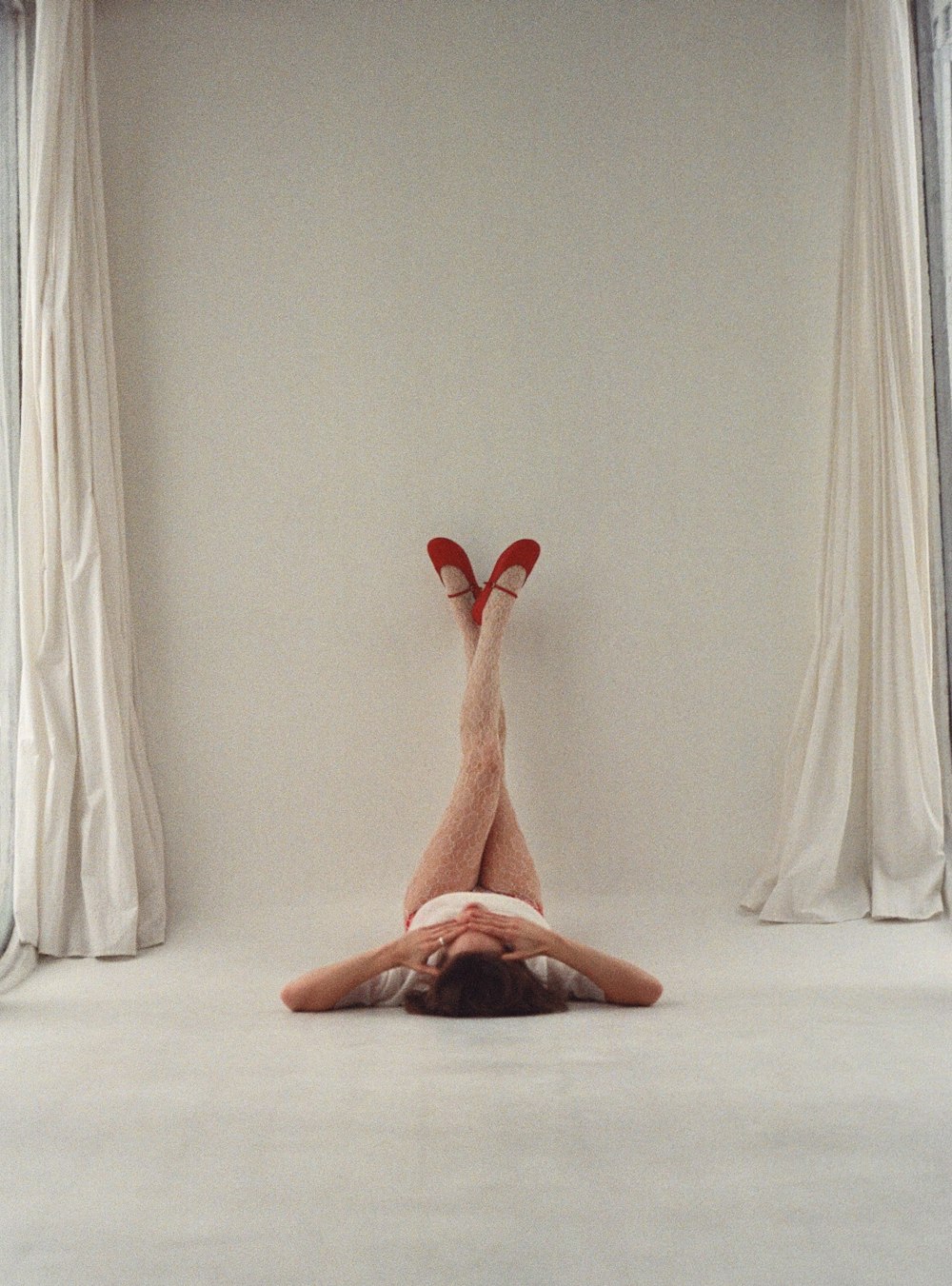 a person laying on their back on a bed