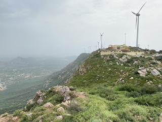 A scenic view of wind turbines on a hillside.
