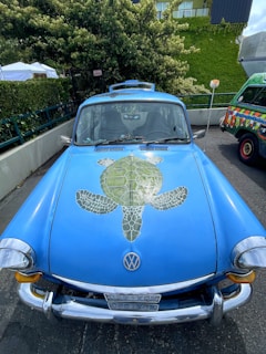A playful scene showing a turtle exploring around a Ferrari F1 car replica with a beer bottle in the background.