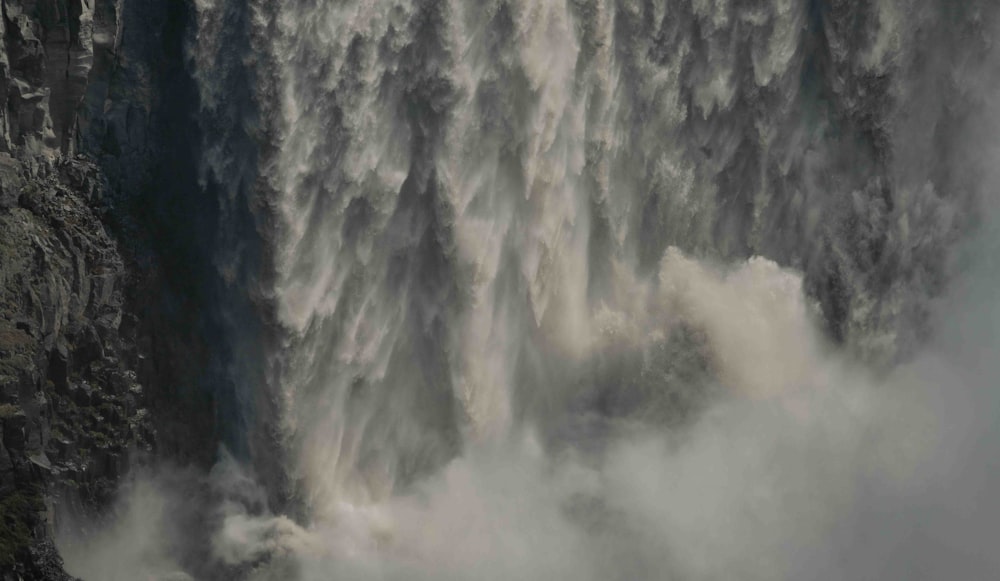 a very tall waterfall with lots of water coming out of it