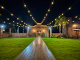 Charming courtyard garden with stone pathways and warm lighting at dusk.