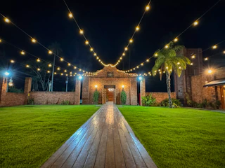 A serene evening backyard softly illuminated by warm soffit and landscape lighting, showcasing a clean, inviting outdoor space.