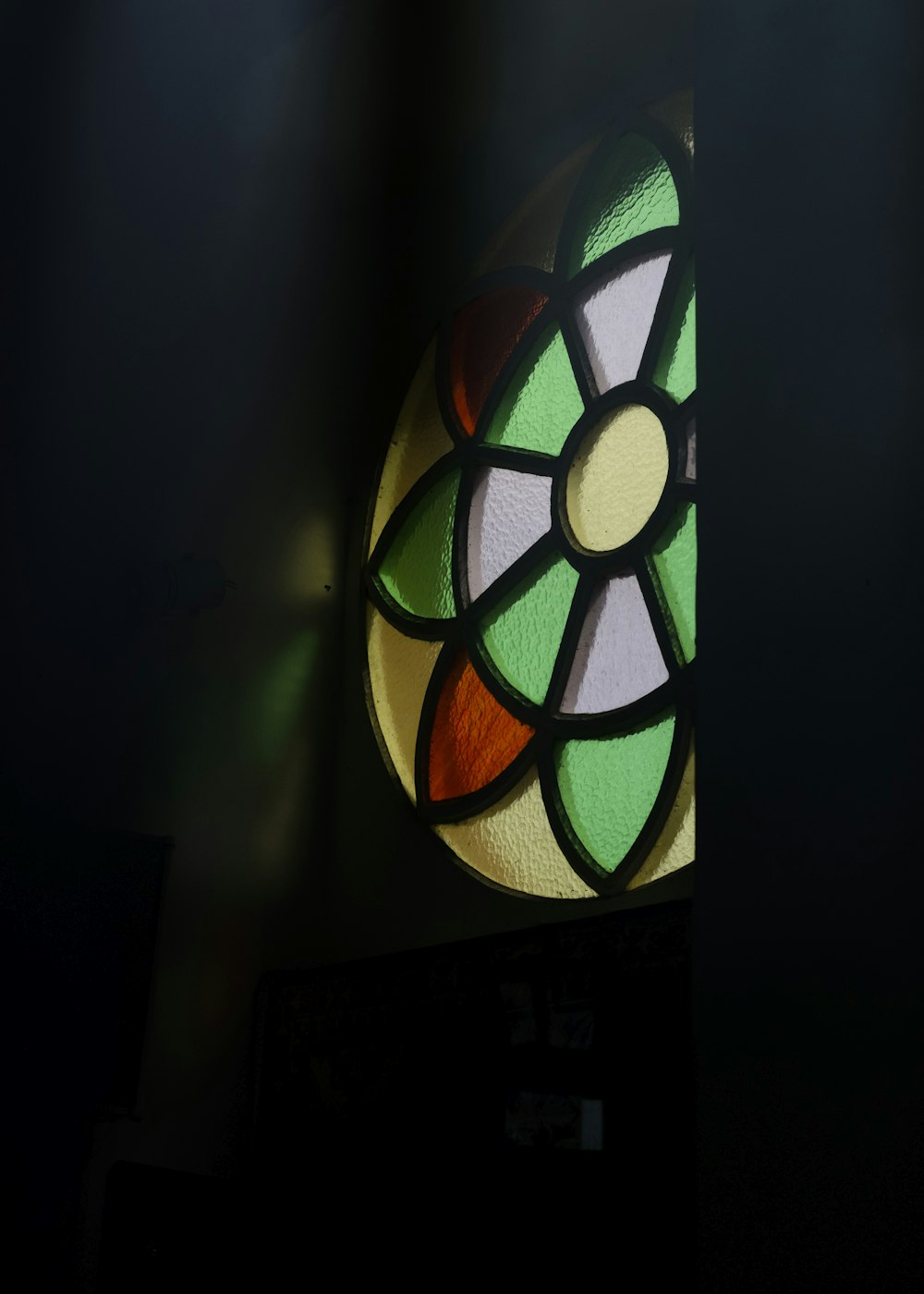 a stained glass window in a dark room