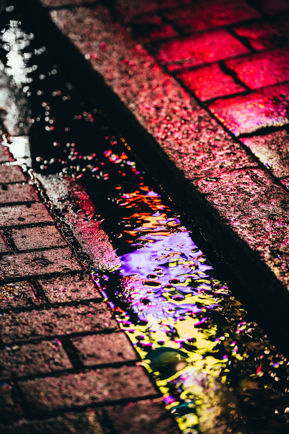 a puddle of water sitting on the side of a road