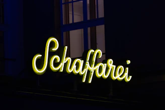 Exterior view of Huefyse in Basel with traditional signage and evening glow