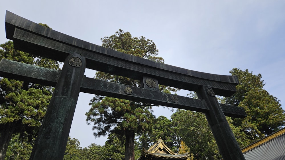 a large wooden gate with a sky in the background