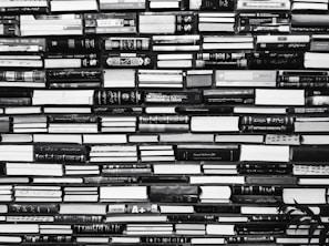 A large collection of books is stacked tightly, covering the entire space from edge to edge. The spines of the books display a variety of titles, some of which include technical and scientific themes. The arrangement appears somewhat chaotic, yet organized in a way that maximizes space.