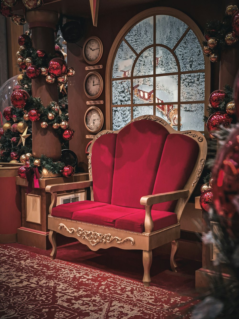 a red chair sitting in front of a window