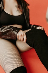 a woman sitting on top of a red couch
