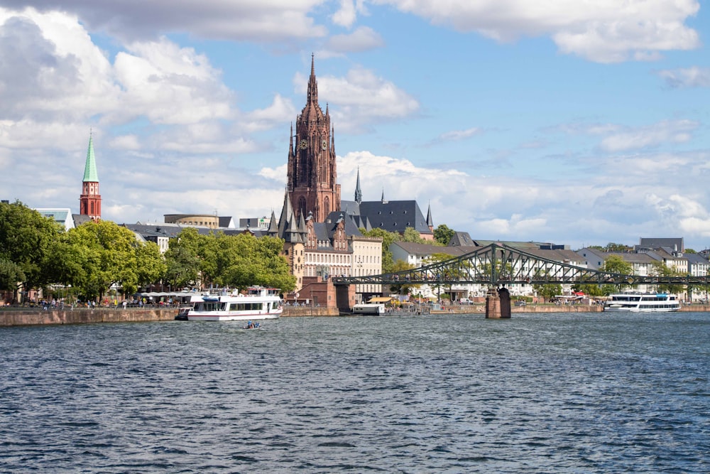 a large cathedral towering over a city next to a river