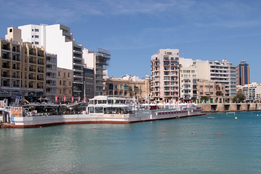 a large boat in the water near a city