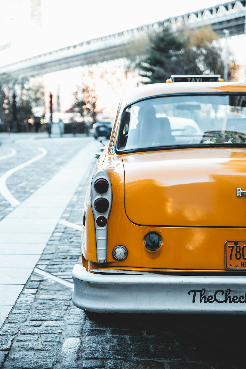 a yellow car parked on the side of the road