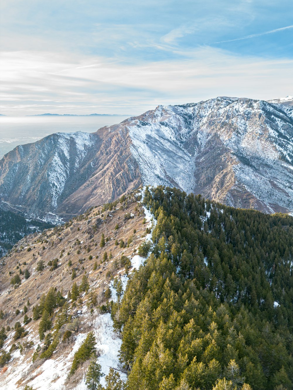 a view of a mountain range with snow on it